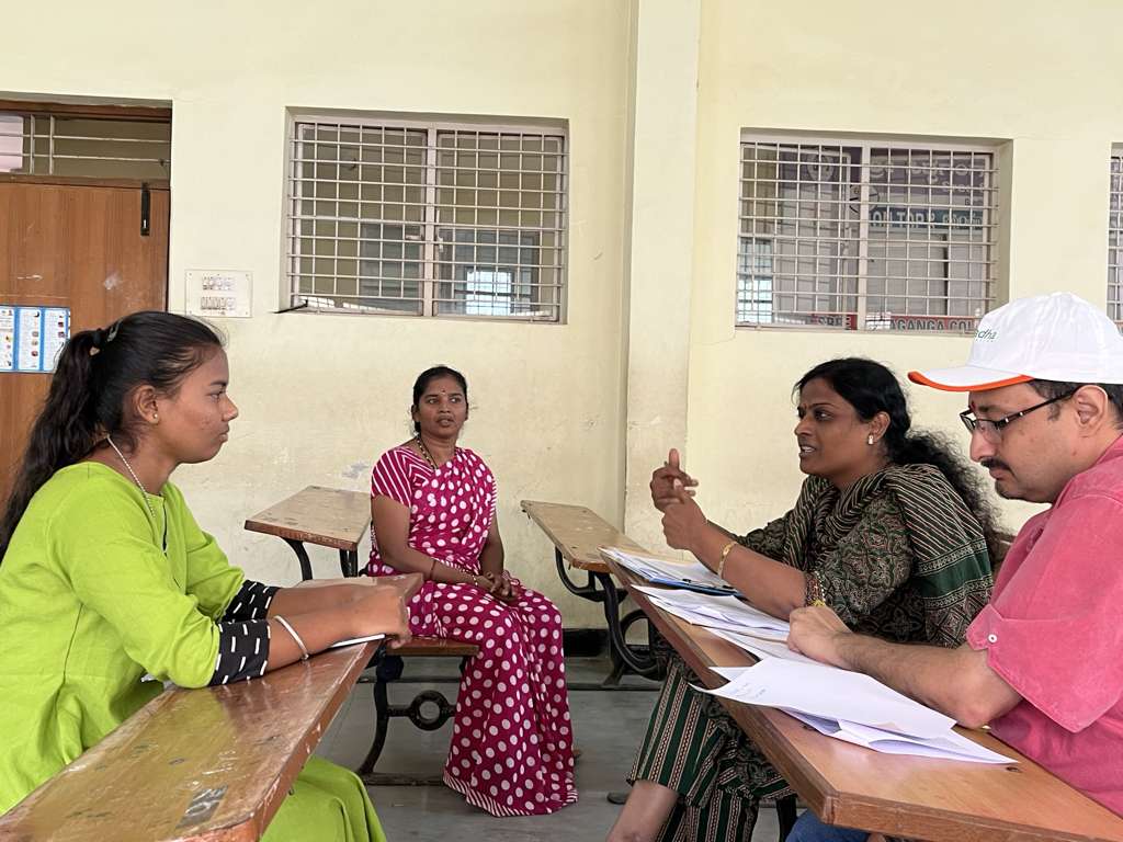 Mentor providing guidance to female scholar and guardian